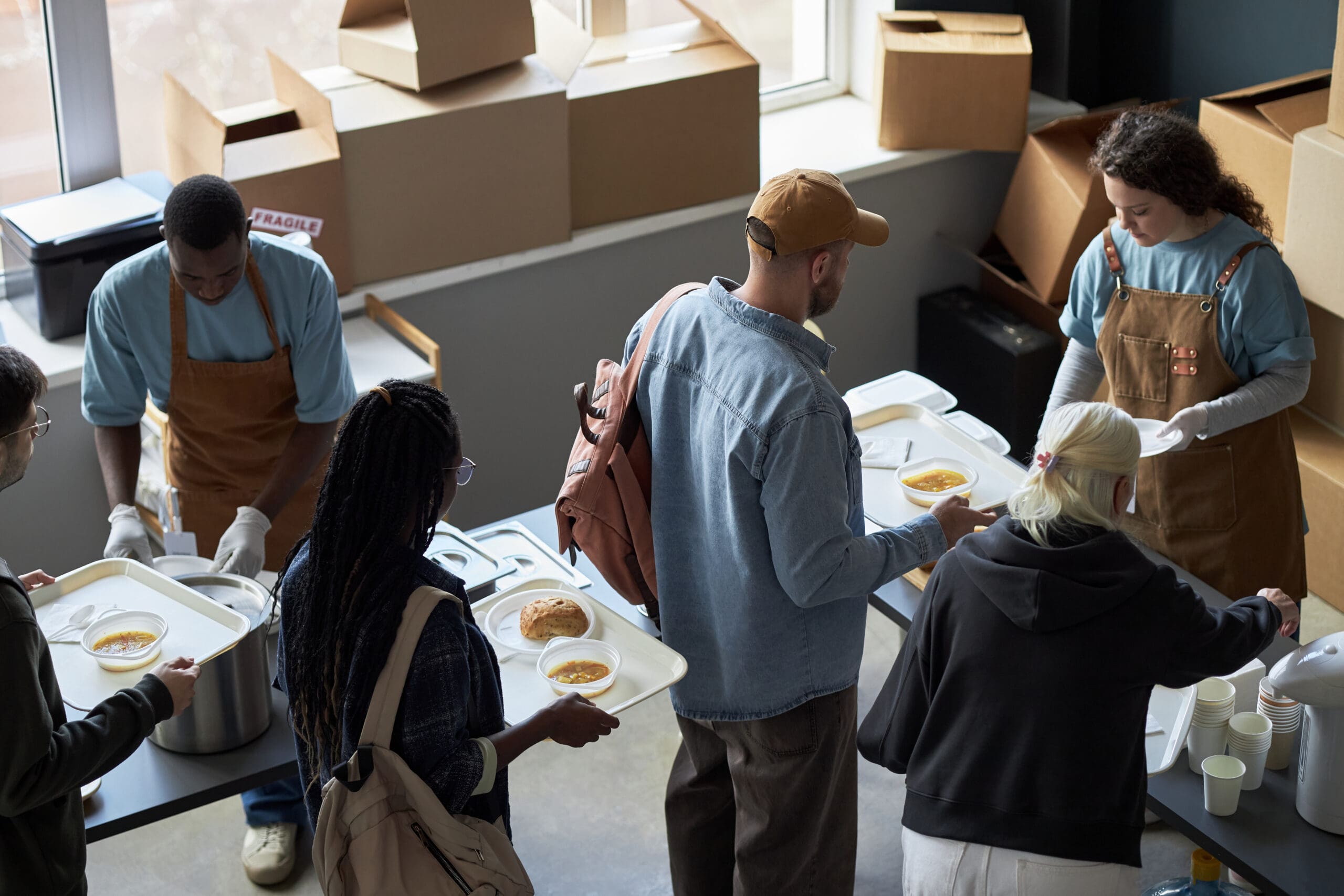 People receiving food at a community kitchen.