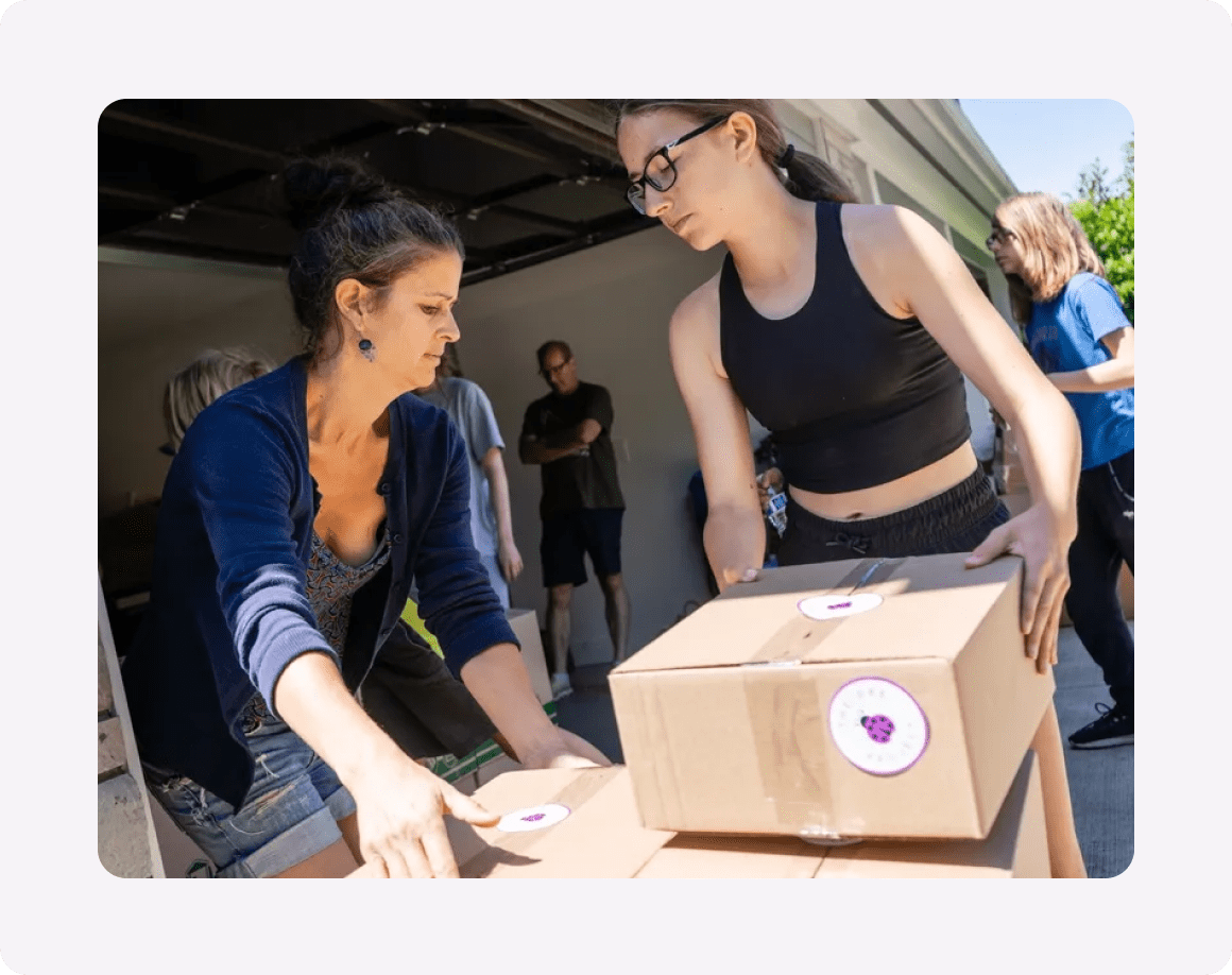 People organizing boxes in a garage.