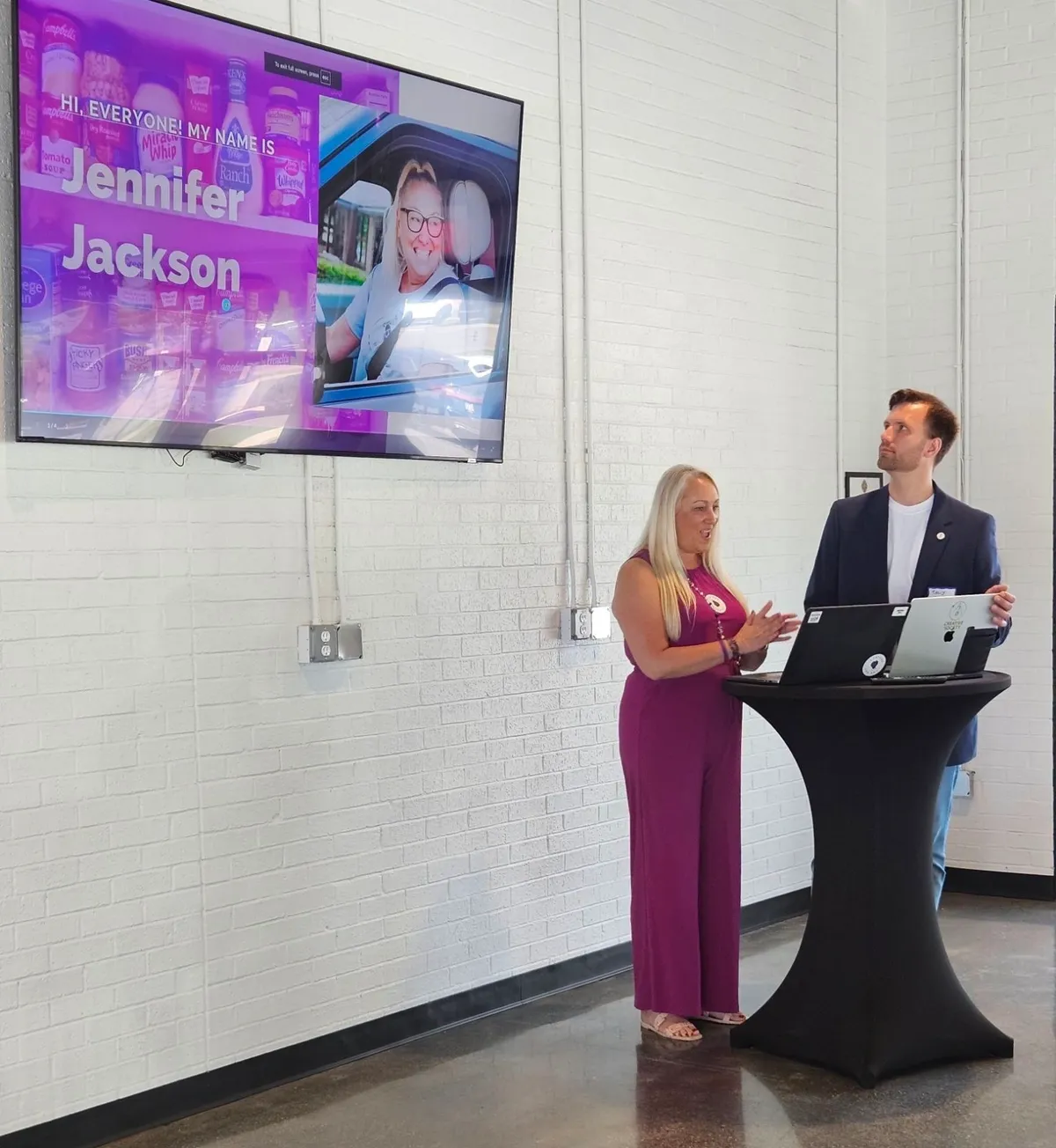 People presenting in front of a screen.